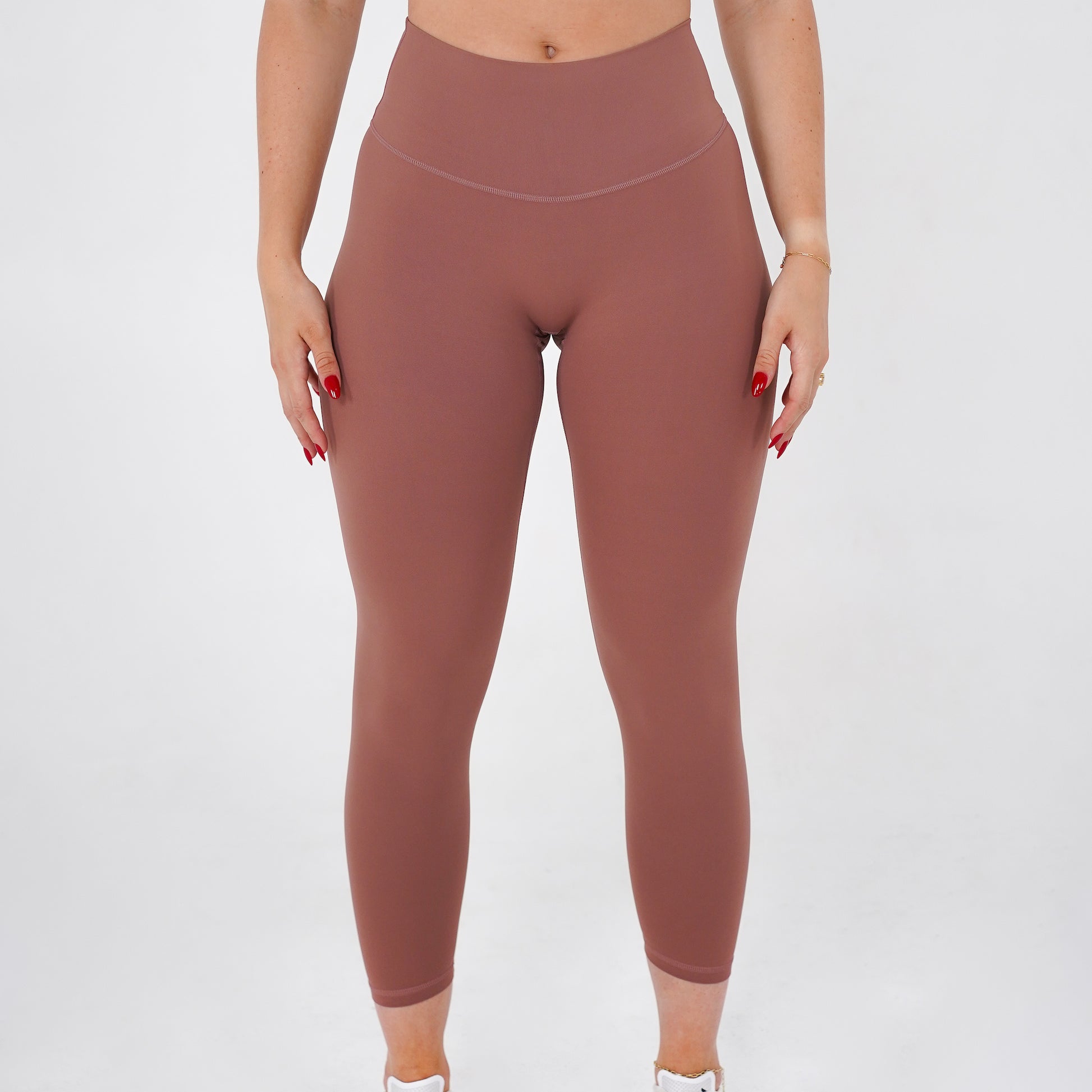 Pineapplebrat founder, influencer Alice Bozinovski, wears the Essential Leggings in Dusted Rose. No front seam, high-rise design, and a blend of 80% nylon, 20% spandex for breathability and sculpting. Perfect for all-day wear.