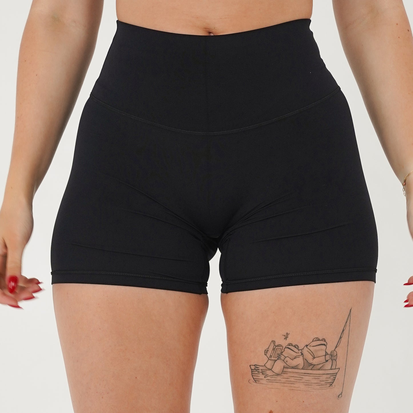 Pineapplebrat founder, influencer Alice Bozinovski, wears the Essential Shorts in Black. Smooth comfort with our 5” inseam shorts—no front seam, high-rise design, and a blend of 80% nylon, 20% spandex for breathability and sculpting. Perfect for all-day wear.