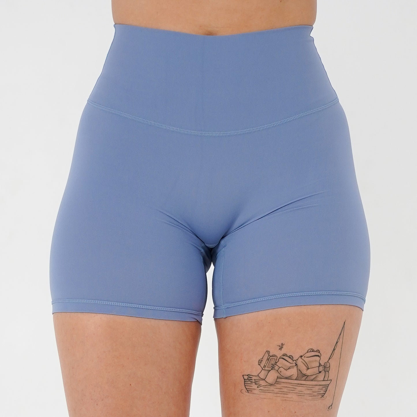Pineapplebrat founder, influencer Alice Bozinovski, wears the Essential Shorts in Dusted Blue. Smooth comfort with our 5” inseam shorts—no front seam, high-rise design, and a blend of 80% nylon, 20% spandex for breathability and sculpting. Perfect for all-day wear.