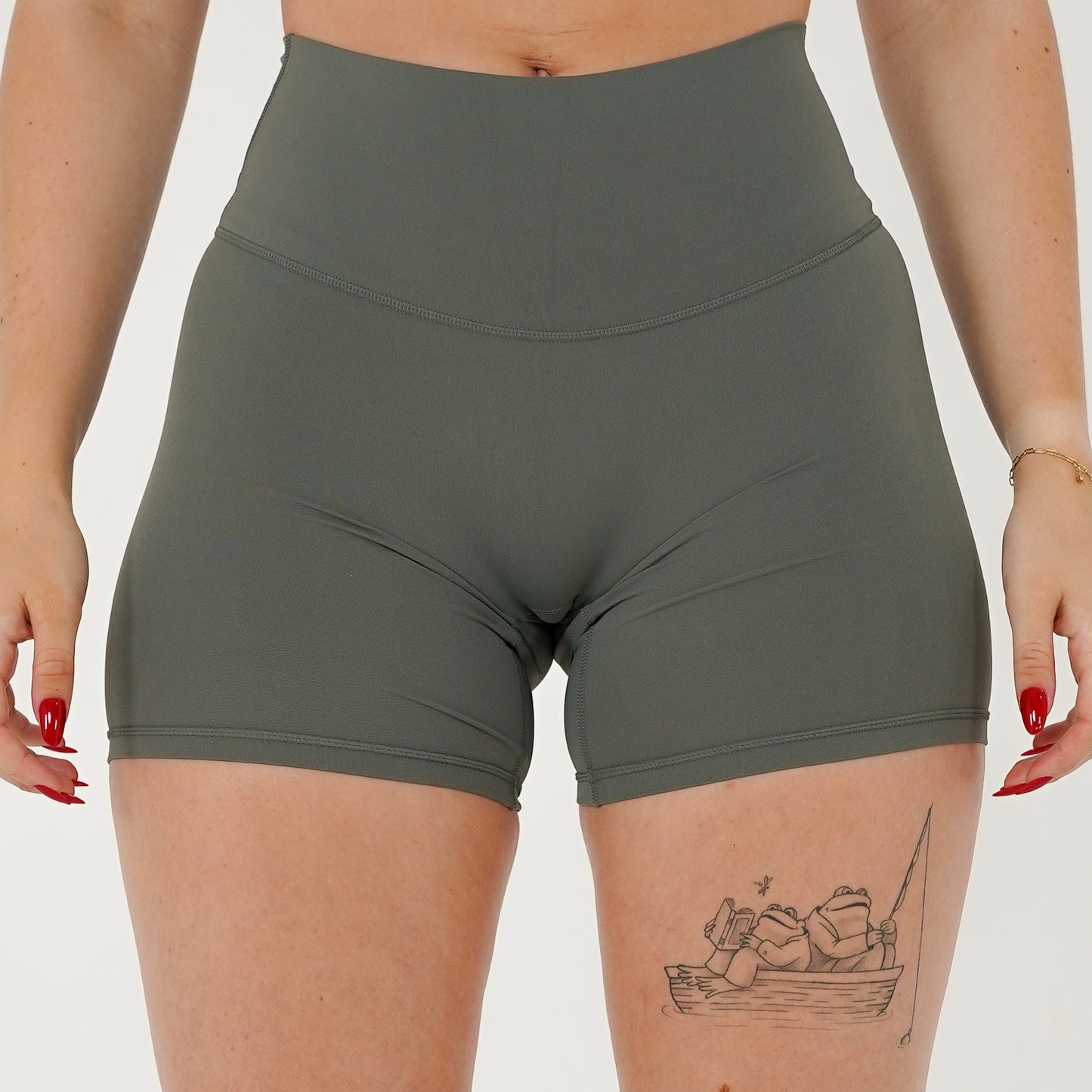 Pineapplebrat founder, influencer Alice Bozinovski, wears the Essential Shorts in Sage. Smooth comfort with our 5” inseam shorts—no front seam, high-rise design, and a blend of 80% nylon, 20% spandex for breathability and sculpting. Perfect for all-day wear.