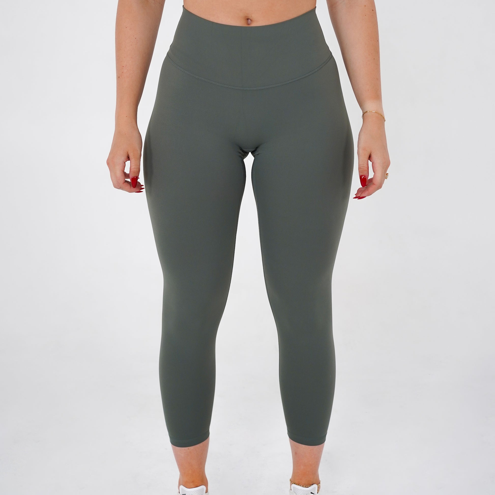 Pineapplebrat founder, influencer Alice Bozinovski, wears the Essential Leggings in Sage. No front seam, high-rise design, and a blend of 80% nylon, 20% spandex for breathability and sculpting. Perfect for all-day wear.